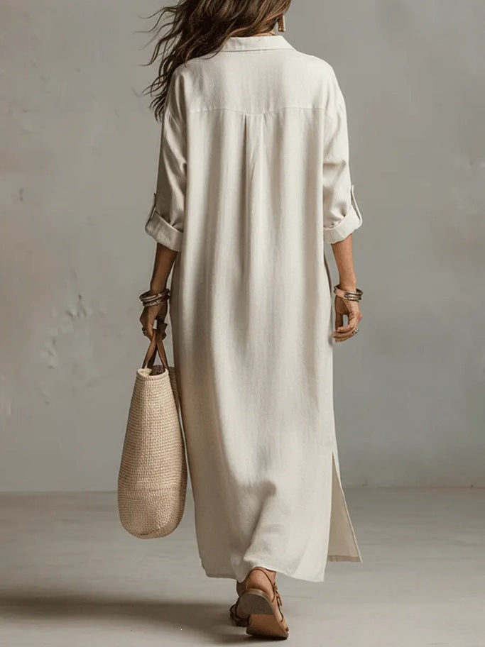A Beige Linen Shirt Dress With A Relaxed French Vacation Vibe, Featuring A Turned-down Collar With A Half-placket, Rolled-up Sleeves, Side-slit Pockets, And A Long Shirt Dress Designperfect For Trave